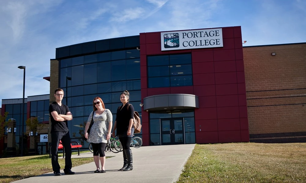 Outside of the Portage College building in Alberta with students standing in front of building